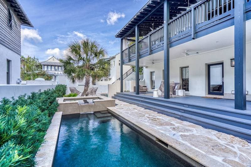 Bright poolside scene with resort-style water and lounge seating.
